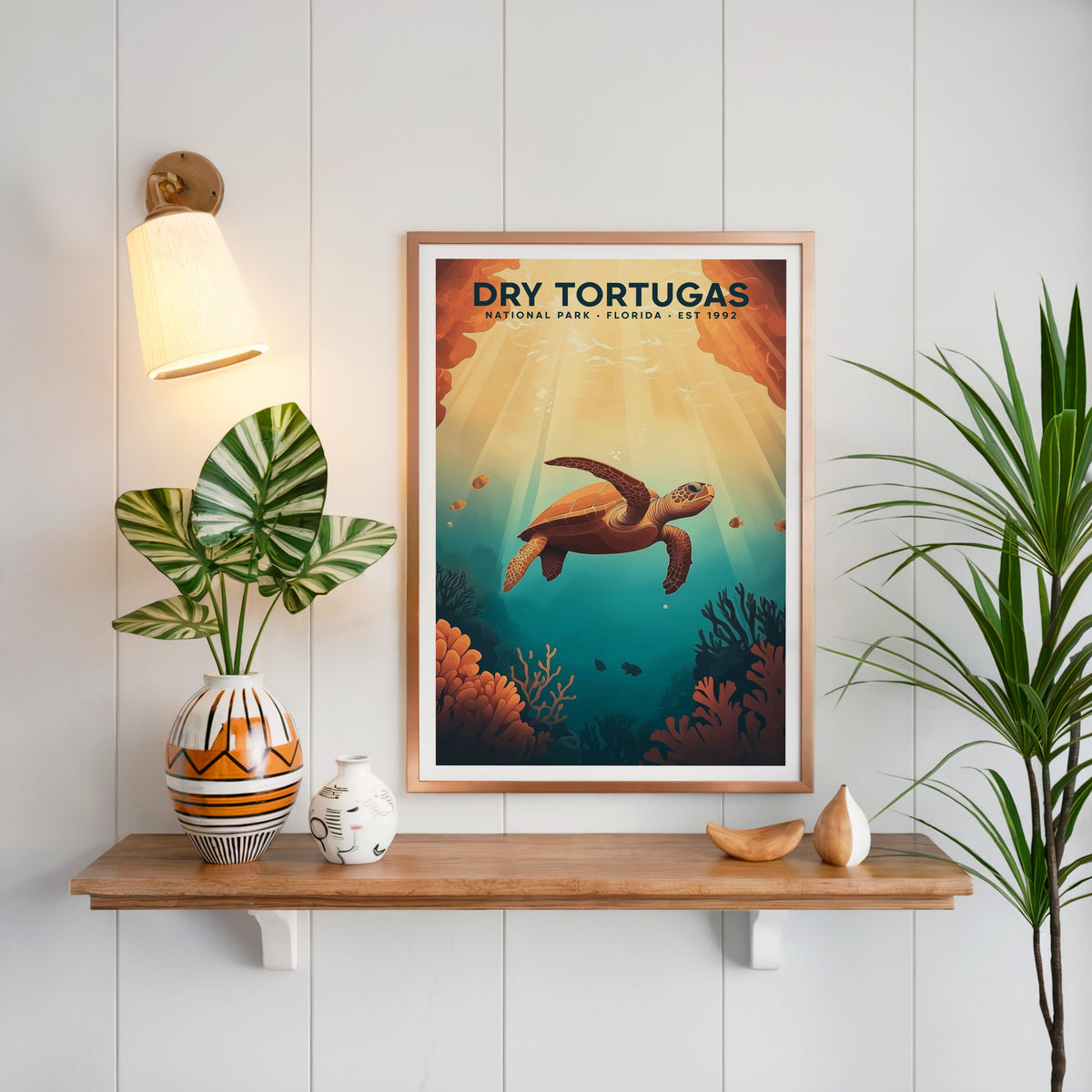 Dry Tortugas National Park print in a copper frame above an oak shelf on white shiplap