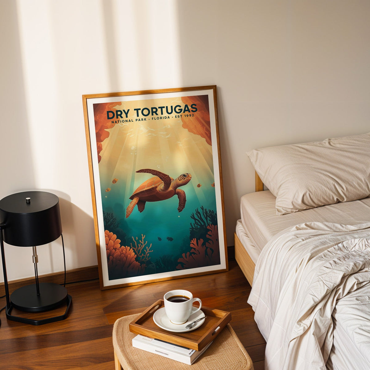 Dry Tortugas National Park print in an oak frame leaning on a bedroom floor beside the bed