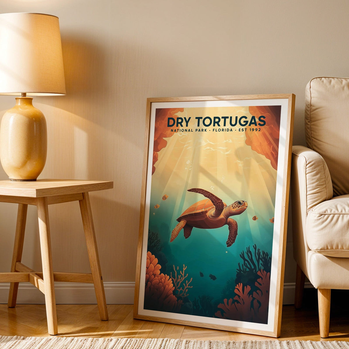 Dry Tortugas print in an oak frame beside a cream armchair and an amber lamp in warm light