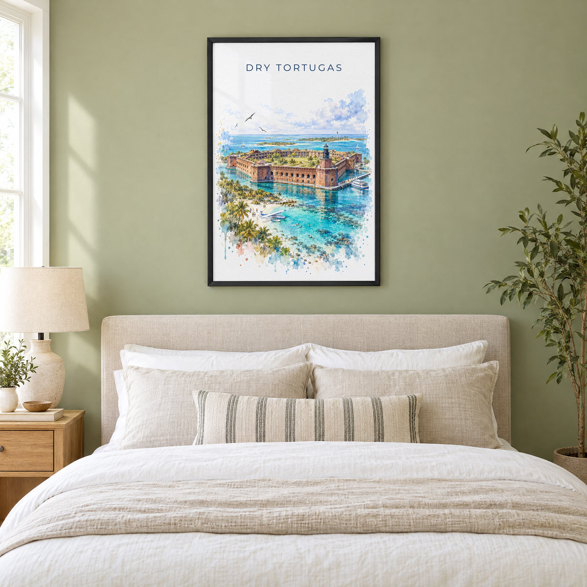 Dry Tortugas National Park watercolor print in a black frame above an upholstered headboard in a sage green bedroom