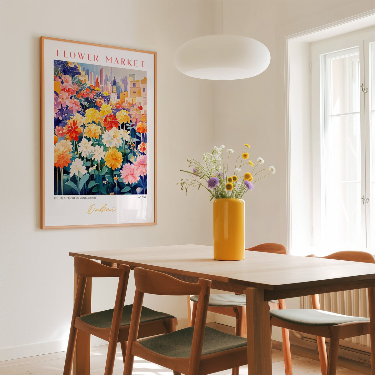 Dubai flower market print in an oak frame above a dining table with a yellow vase and white pendant light