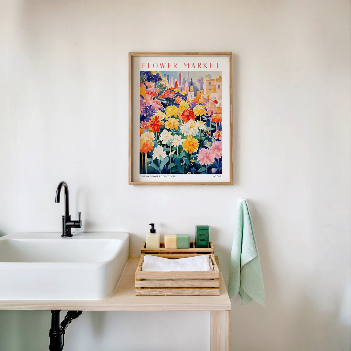 Dubai flower market print in an oak frame above a white bathroom sink with folded towels