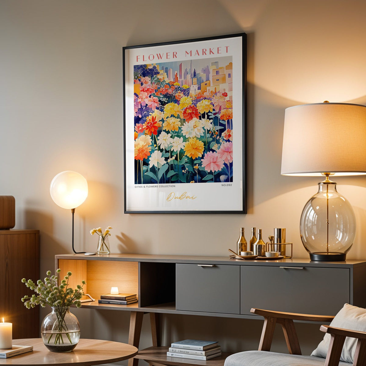 Dubai flower market print in a black frame above a grey media console with a glass table lamp