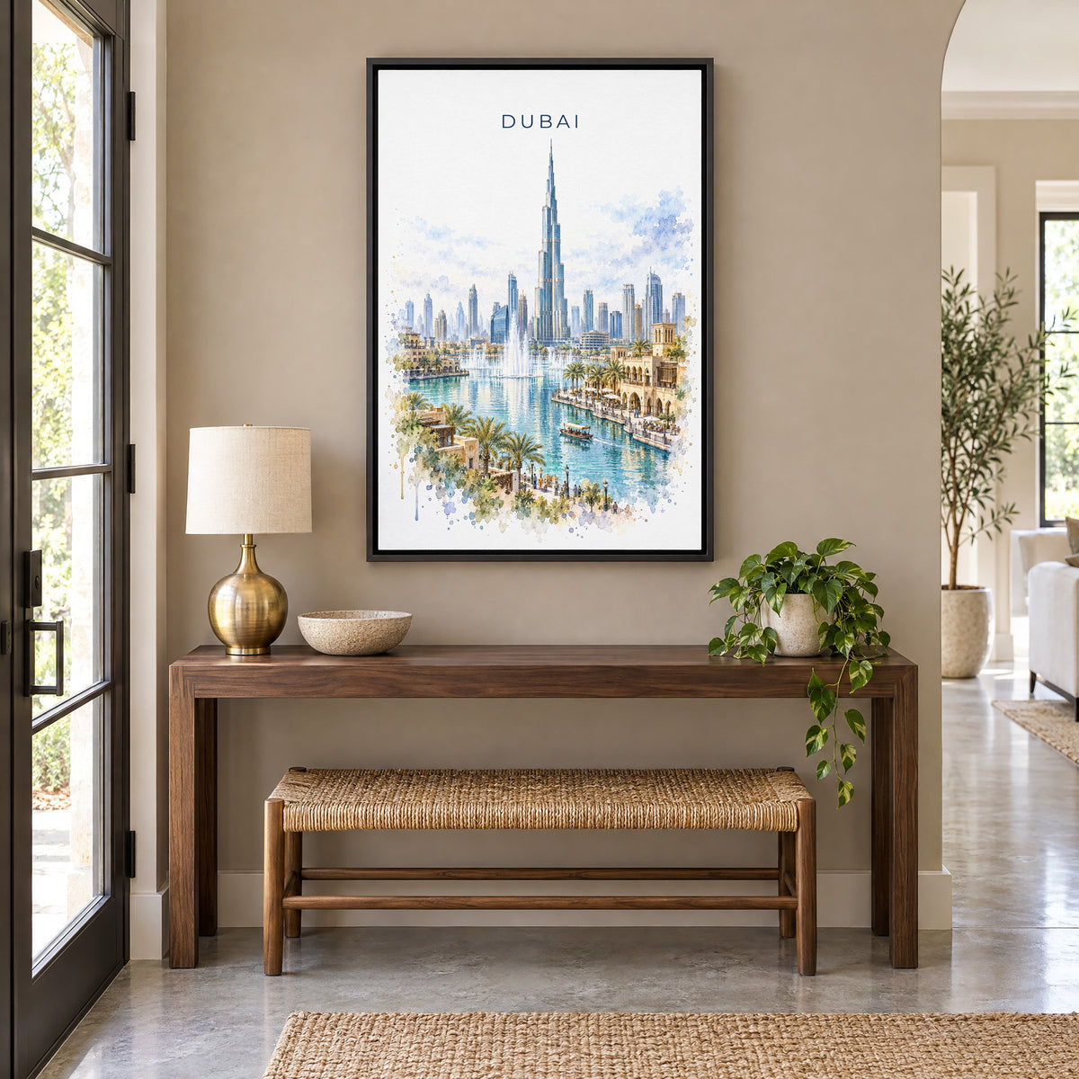 Dubai watercolor print as a black floater canvas above a walnut console and woven bench in an entryway