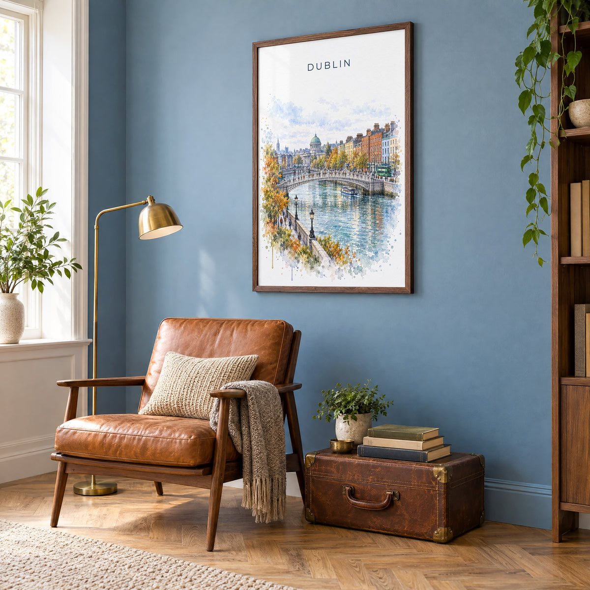 Dublin watercolor print in a walnut frame on a blue wall above a leather armchair in a reading nook