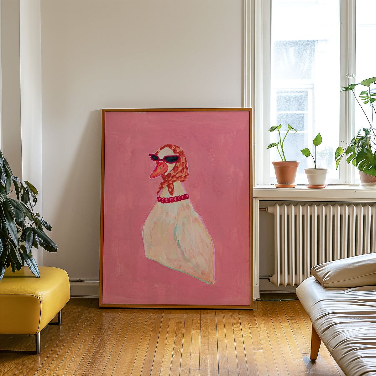 Duck with cat-eye sunglasses print in an oak frame leaning beside a yellow leather bench