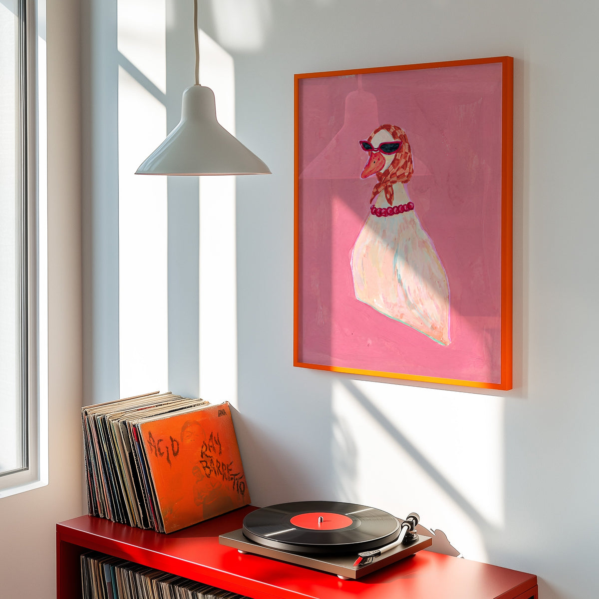 Retro chic duck print shown in an orange frame above a red record cabinet and turntable