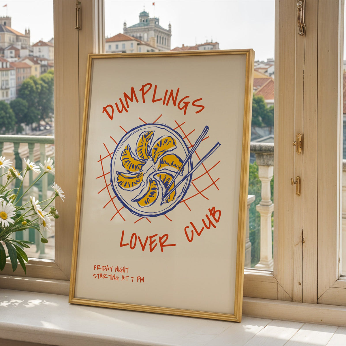 Dumplings Lover Club print in a gold frame on a window sill above a hillside town