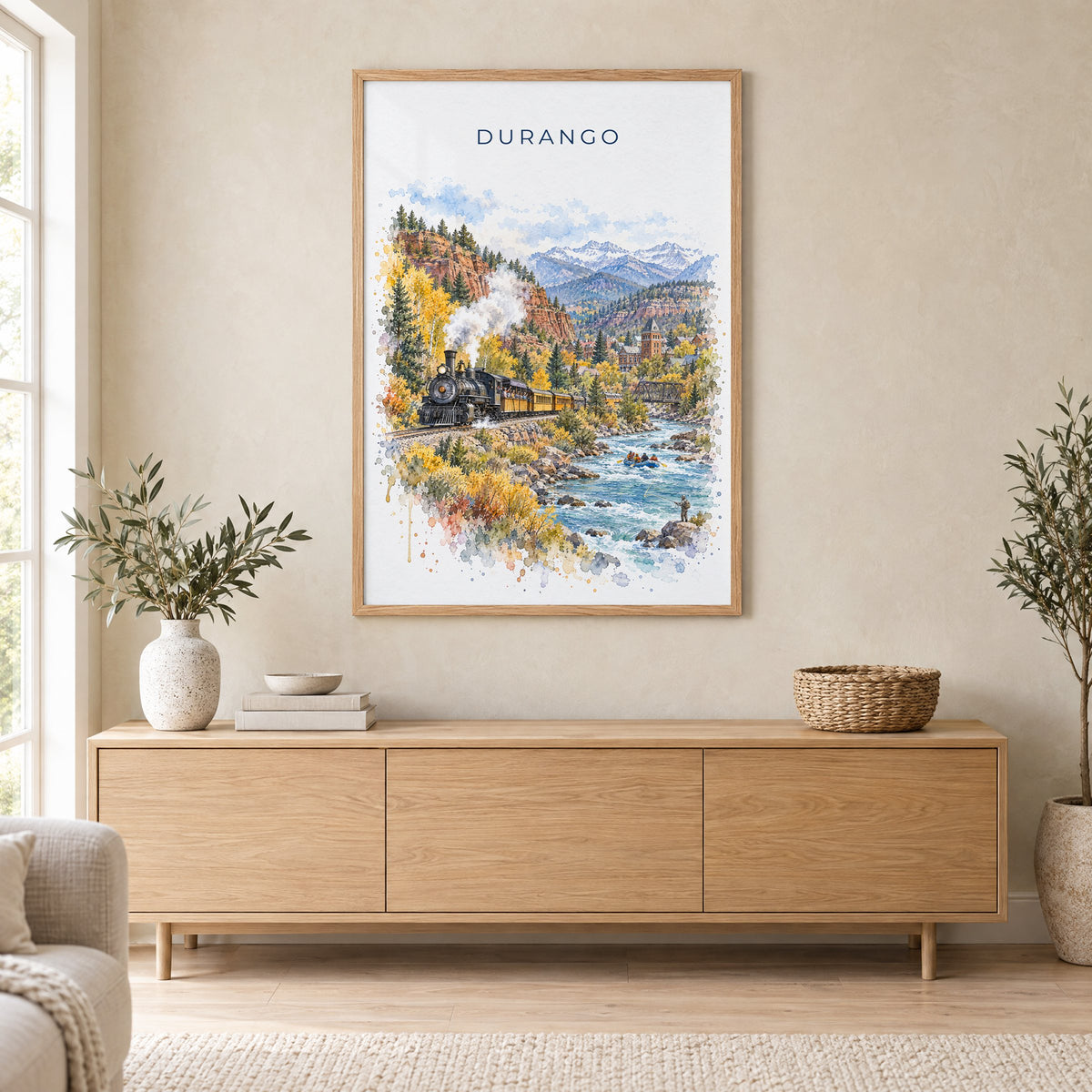 Durango, Colorado watercolor print in an oak frame above a light wood sideboard in a Scandinavian living room