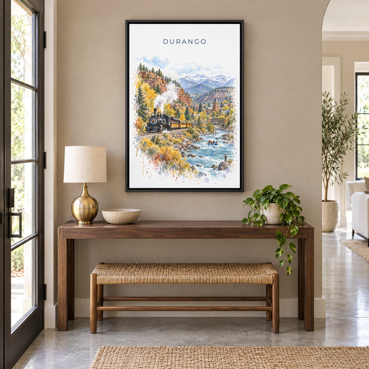 Durango, Colorado watercolor print as a black floater canvas above a walnut console and woven bench in an entryway