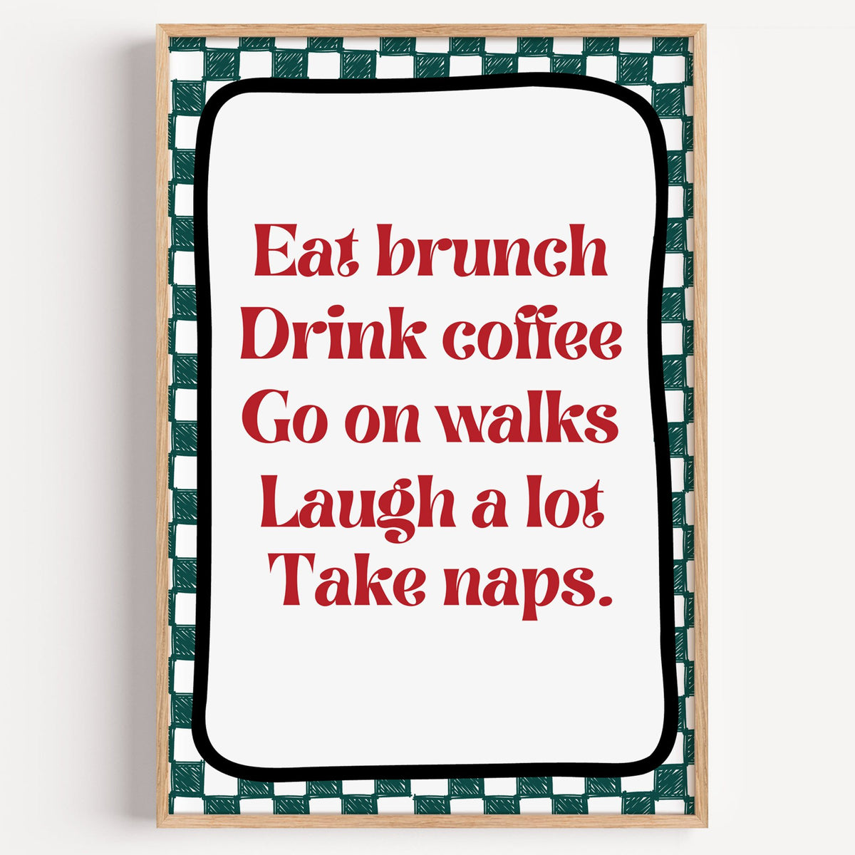 Eat brunch drink coffee check print in a light oak frame on a plain white wall