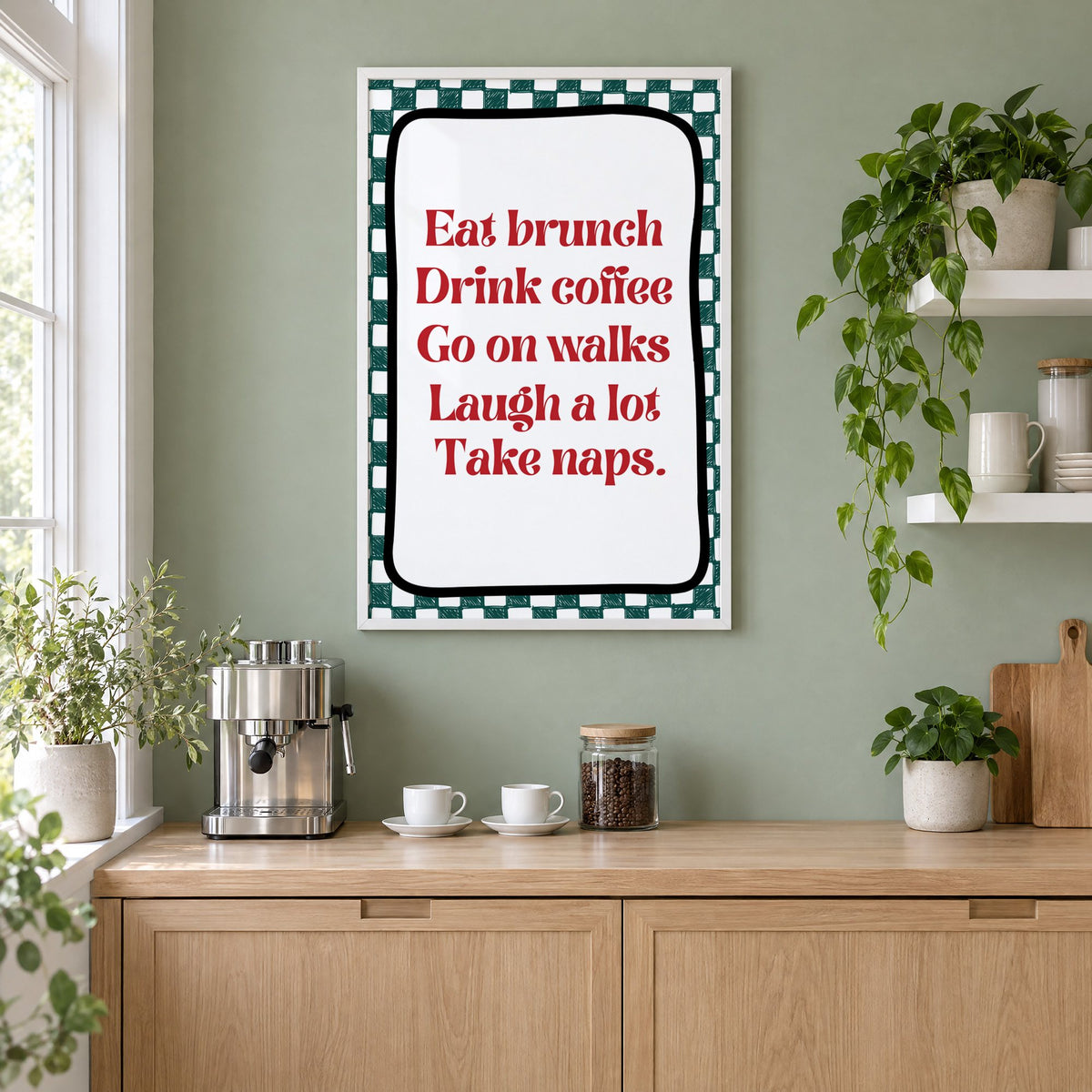 Eat brunch drink coffee check print in a white frame on a sage green coffee nook wall above an espresso machine