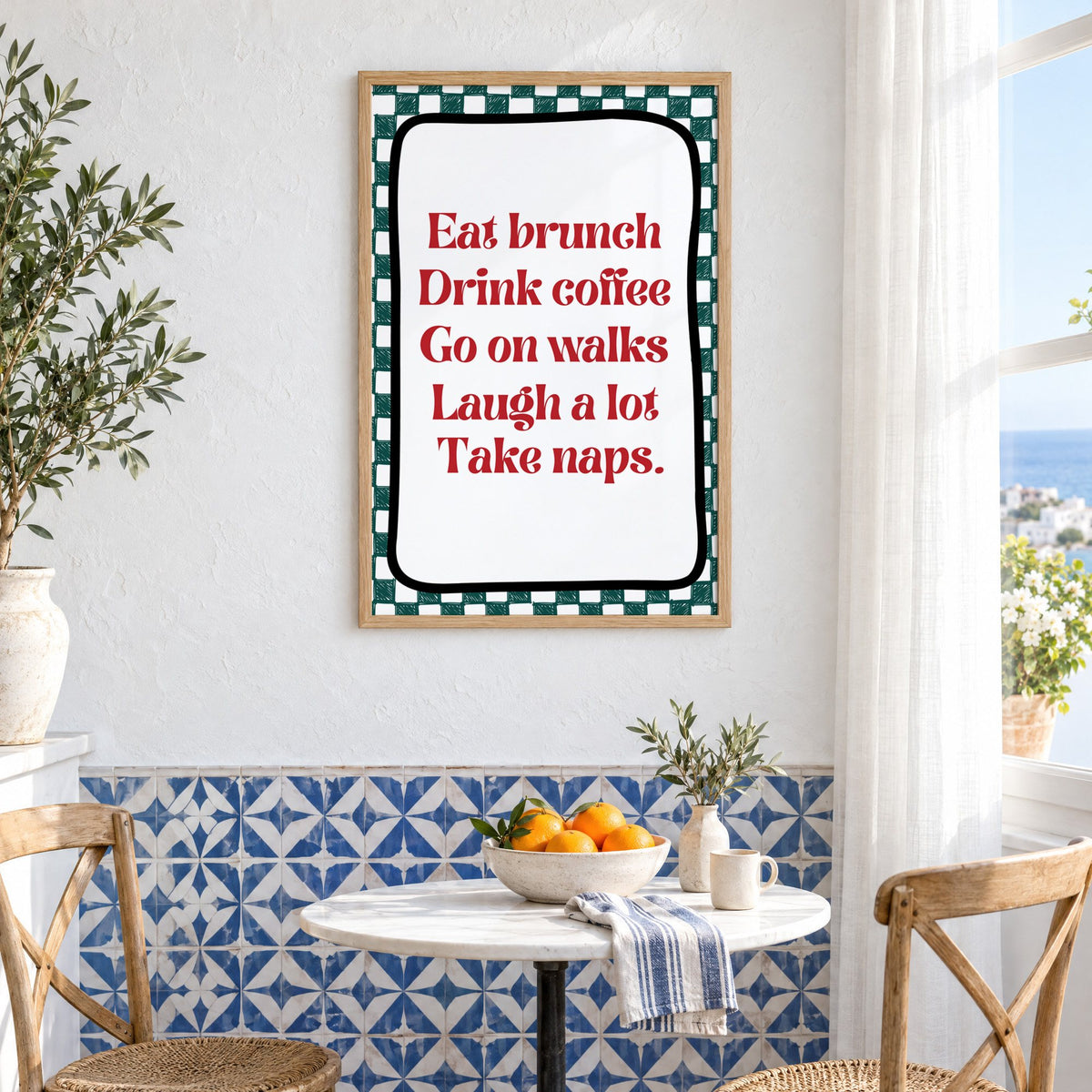Eat brunch drink coffee check print in an oak frame above a bistro table and blue patterned tiles