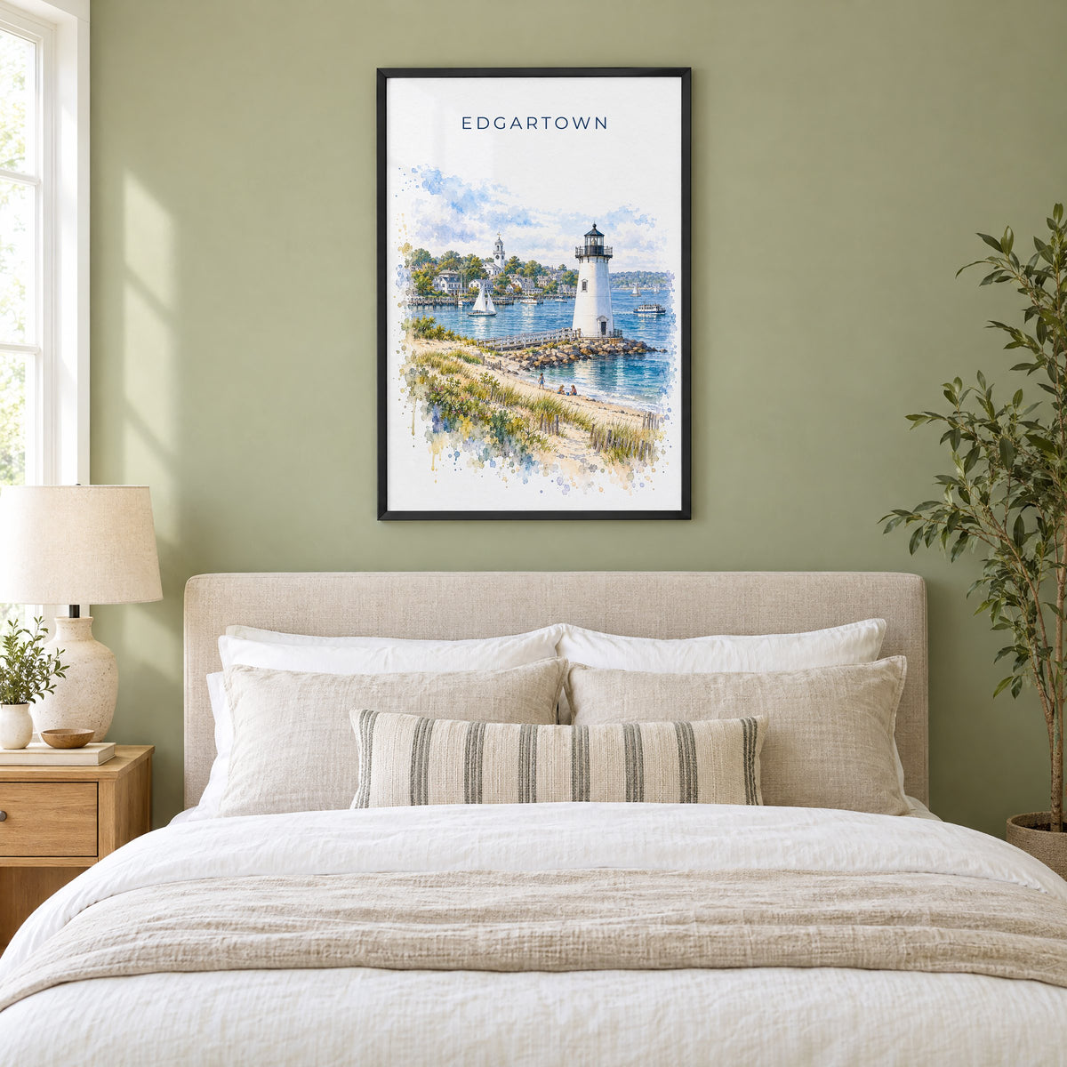 Edgartown watercolor print in a black frame above an upholstered headboard in a sage green bedroom