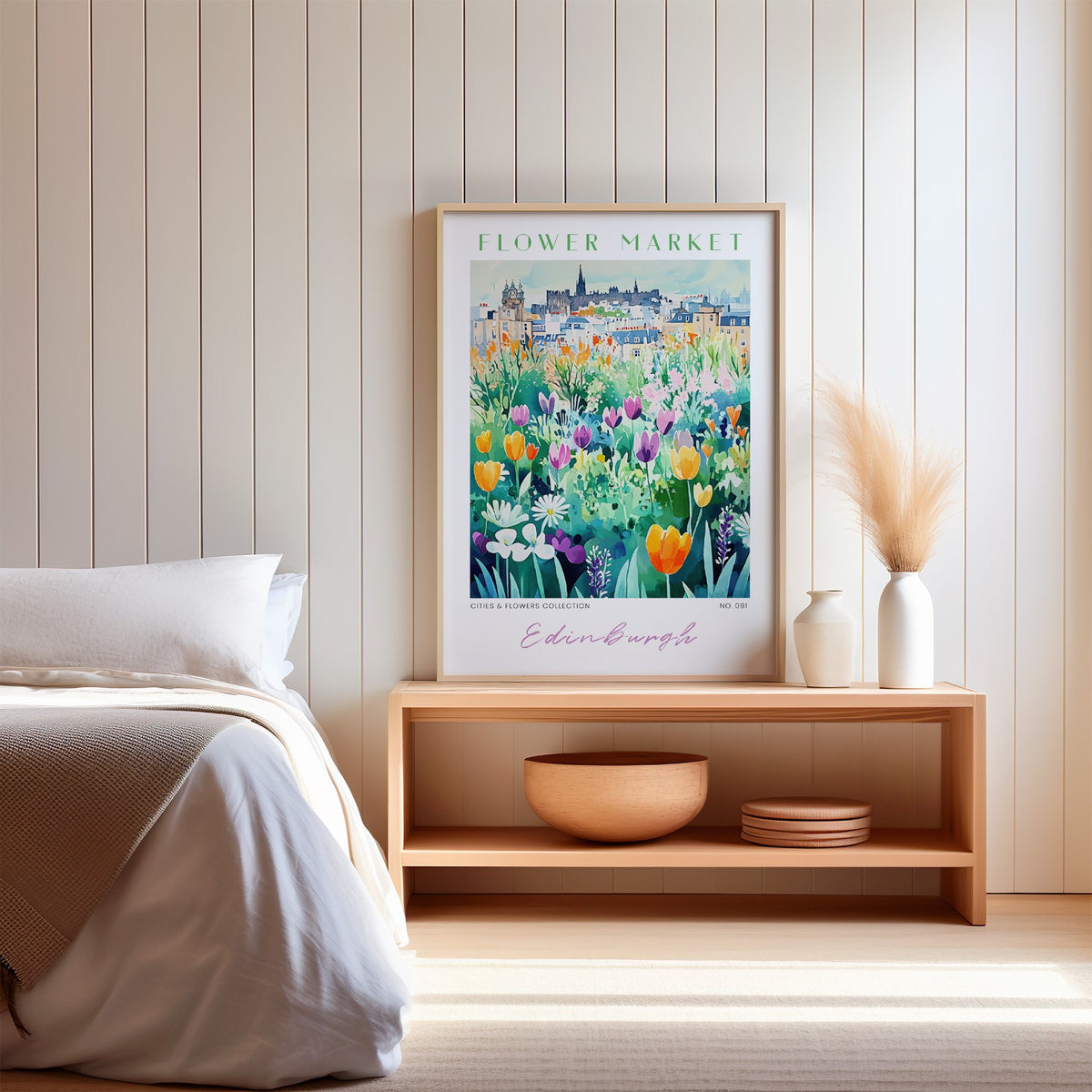 Edinburgh flower market print in an oak frame on a wood bench against a white shiplap bedroom wall with pampas grass