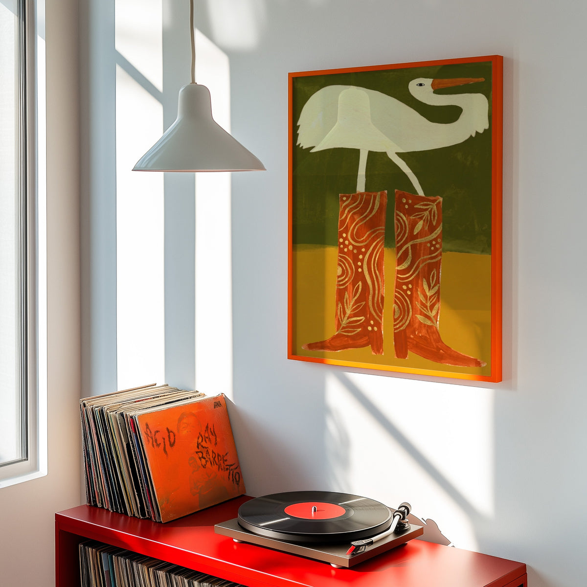 White egret western print shown in an orange frame above a red record cabinet and turntable