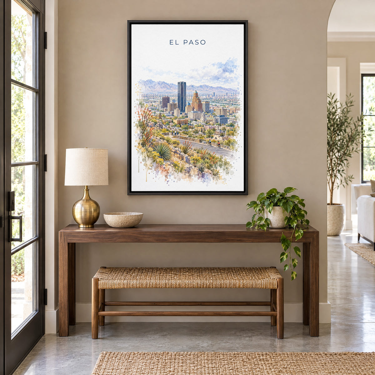 El Paso watercolor print as a black floater canvas above a walnut console and woven bench in an entryway