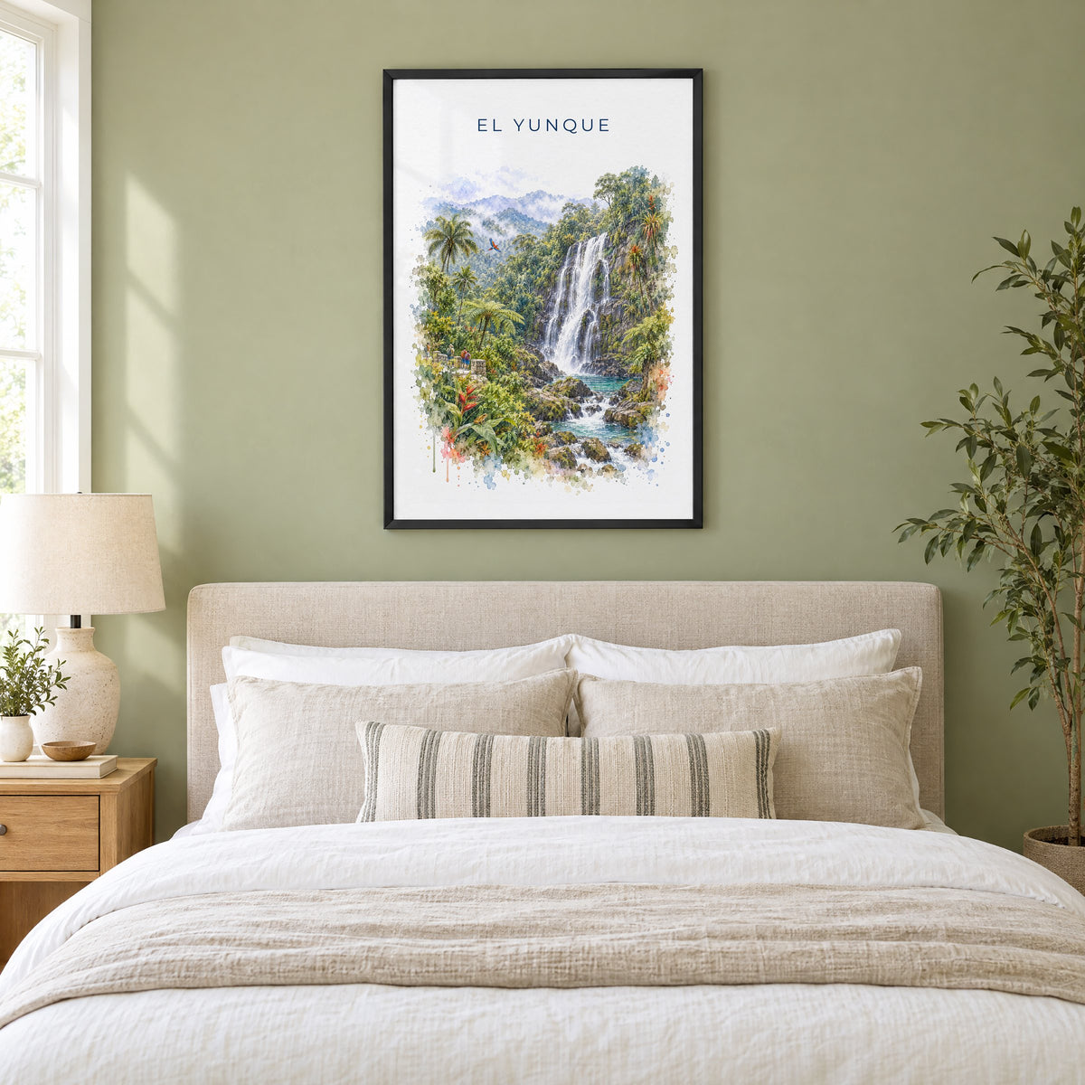 El Yunque watercolor print in a black frame above an upholstered headboard in a sage green bedroom