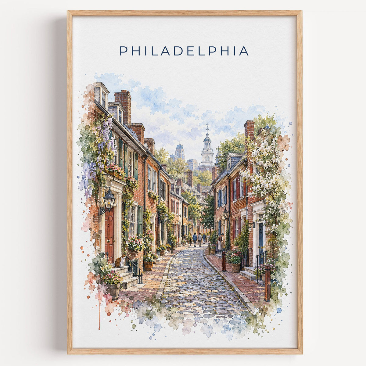Elfreth's Alley Philadelphia watercolor print in a light oak frame on a plain white wall