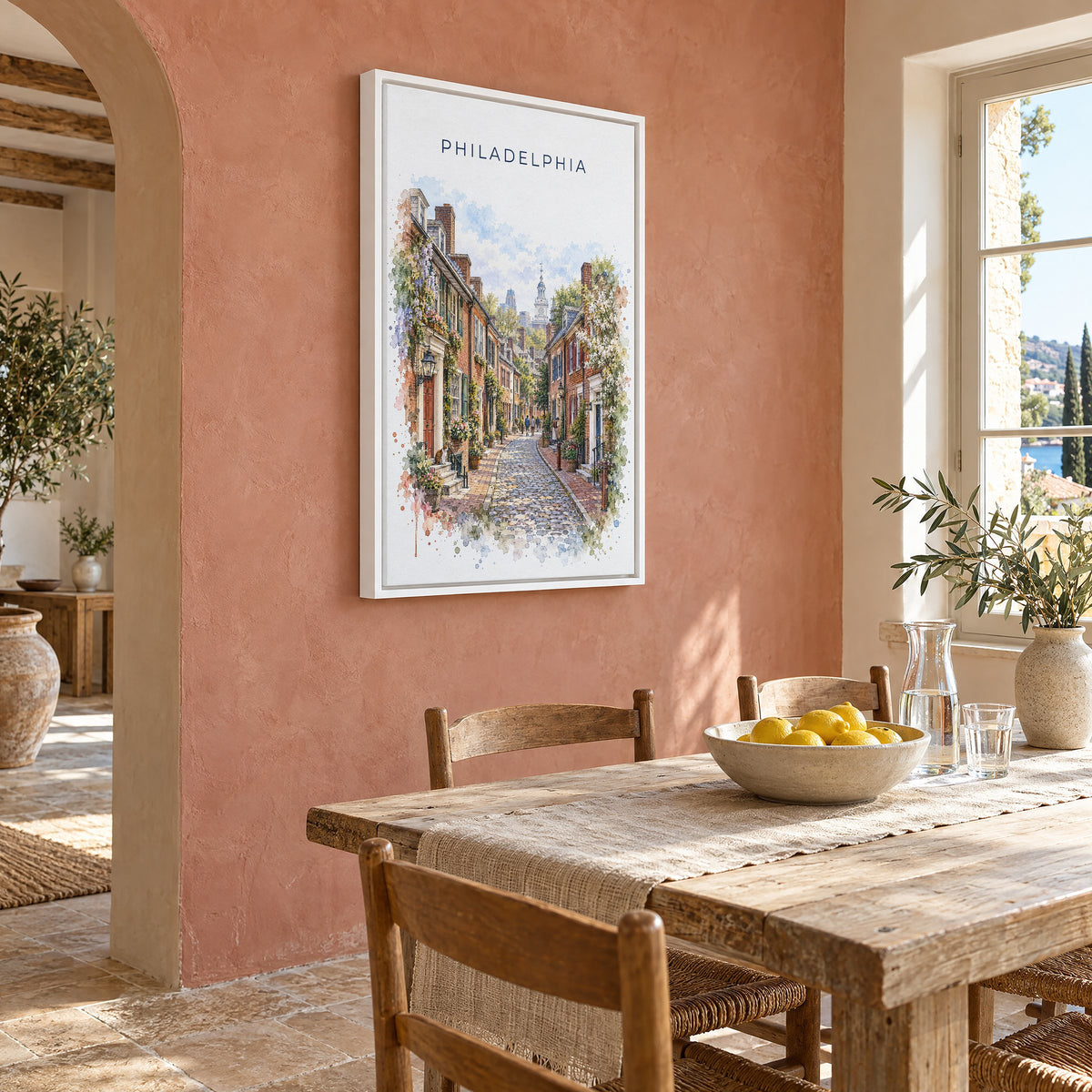 Elfreth's Alley Philadelphia watercolor print as a white floater canvas on a terracotta wall above a rustic dining table