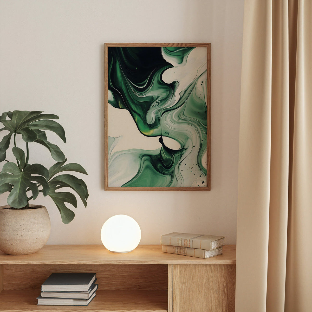 Emerald green fluid marble abstract print in a walnut frame above an oak cabinet with a glowing globe lamp
