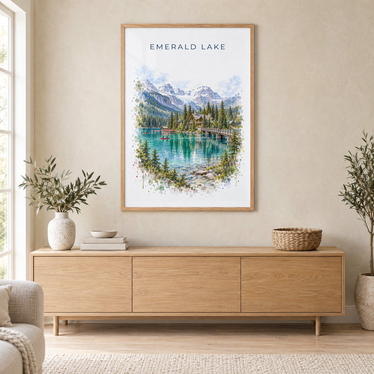 Emerald Lake, BC watercolor print in an oak frame above a light wood sideboard in a Scandinavian living room