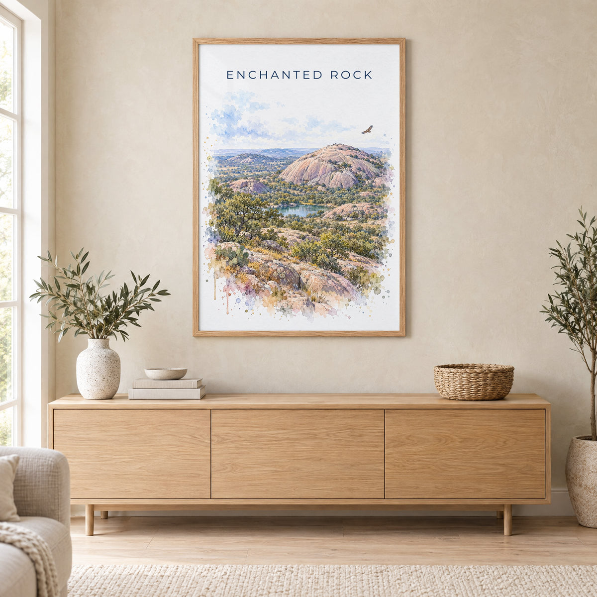 Enchanted Rock watercolor print in an oak frame above a light wood sideboard in a Scandinavian living room