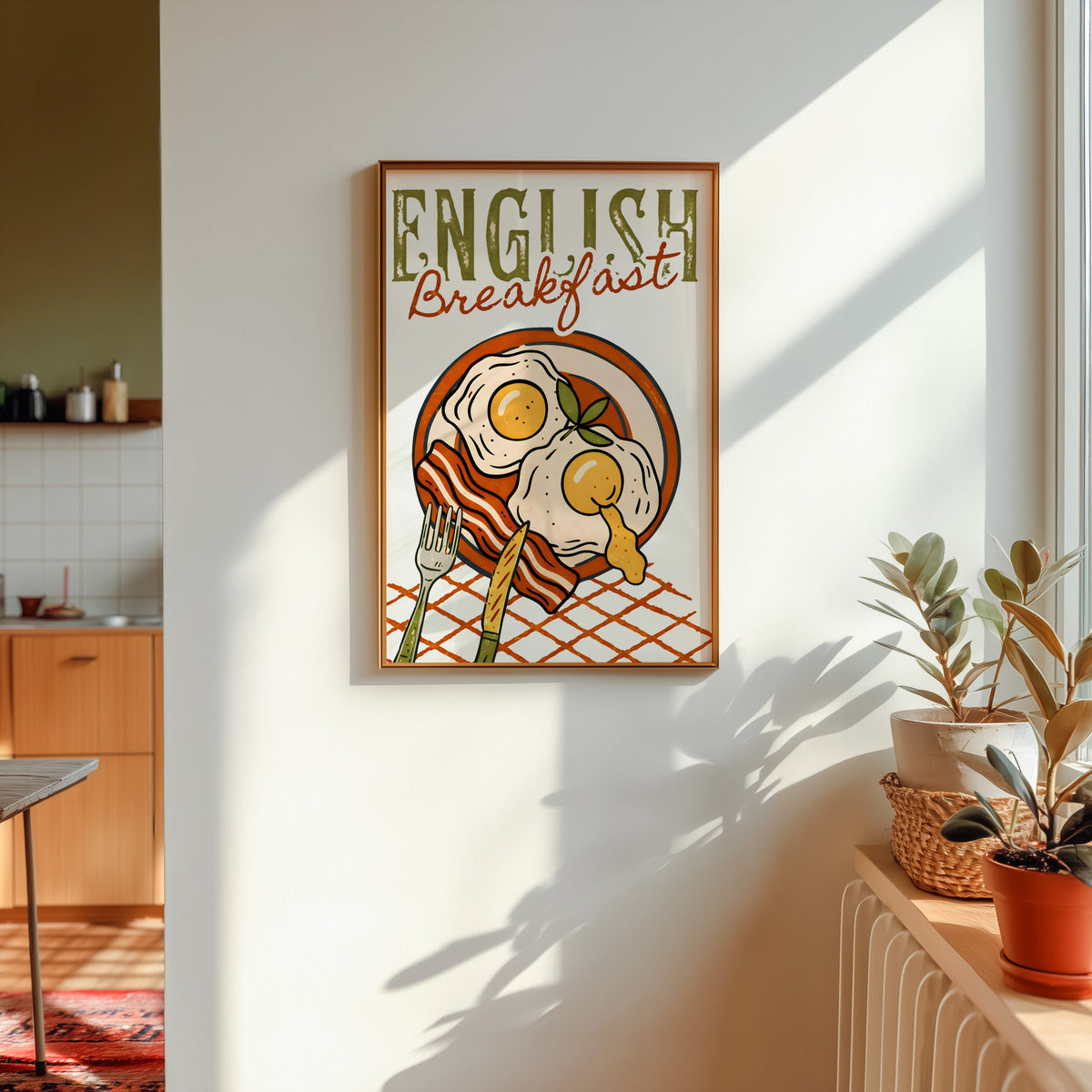English breakfast print in a gold frame in sunlight with plants on the ledge and a kitchen beyond