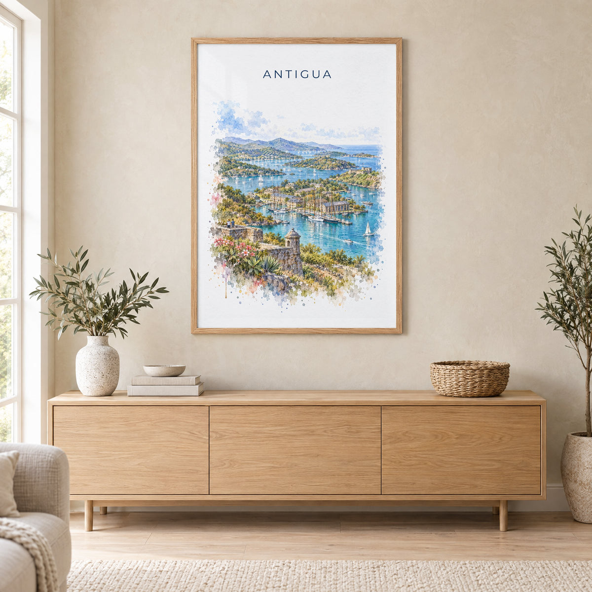 Antigua watercolor print in an oak frame above a light wood sideboard in a Scandinavian living room