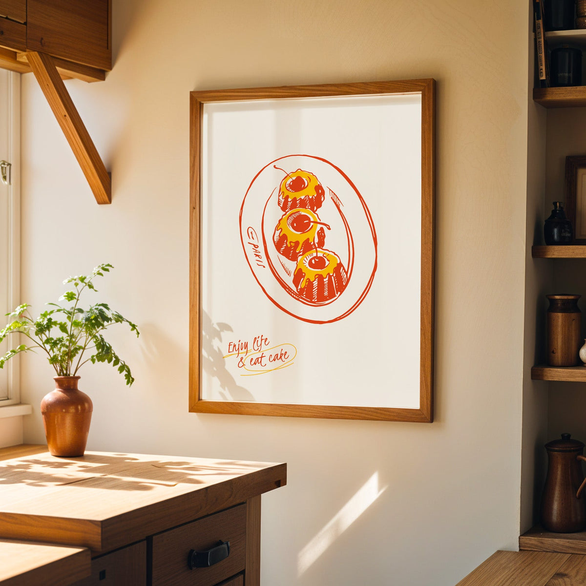Enjoy Life and Eat Cake print in a walnut frame on a cream kitchen wall