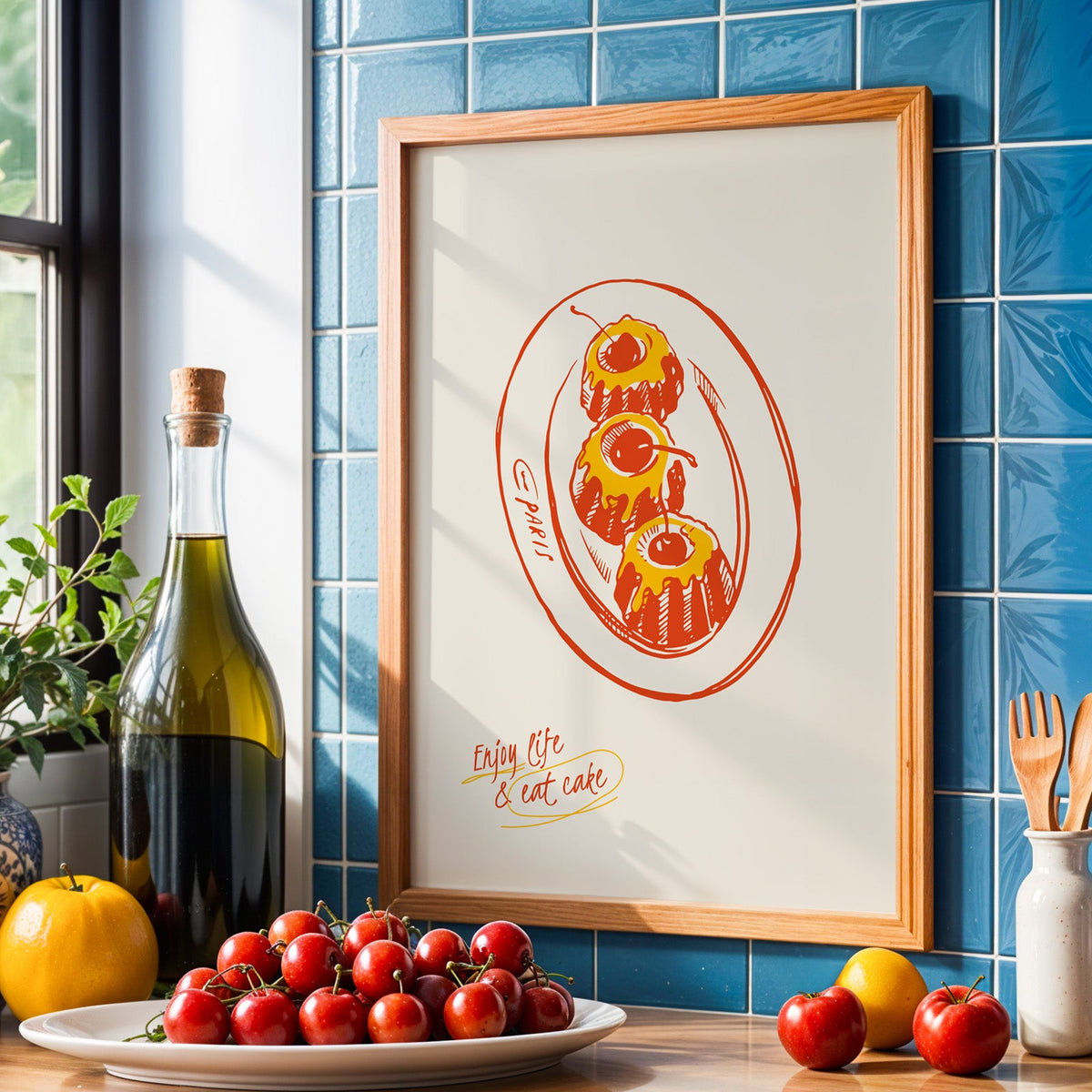 Enjoy Life and Eat Cake print in an oak frame against blue tiles with olive oil