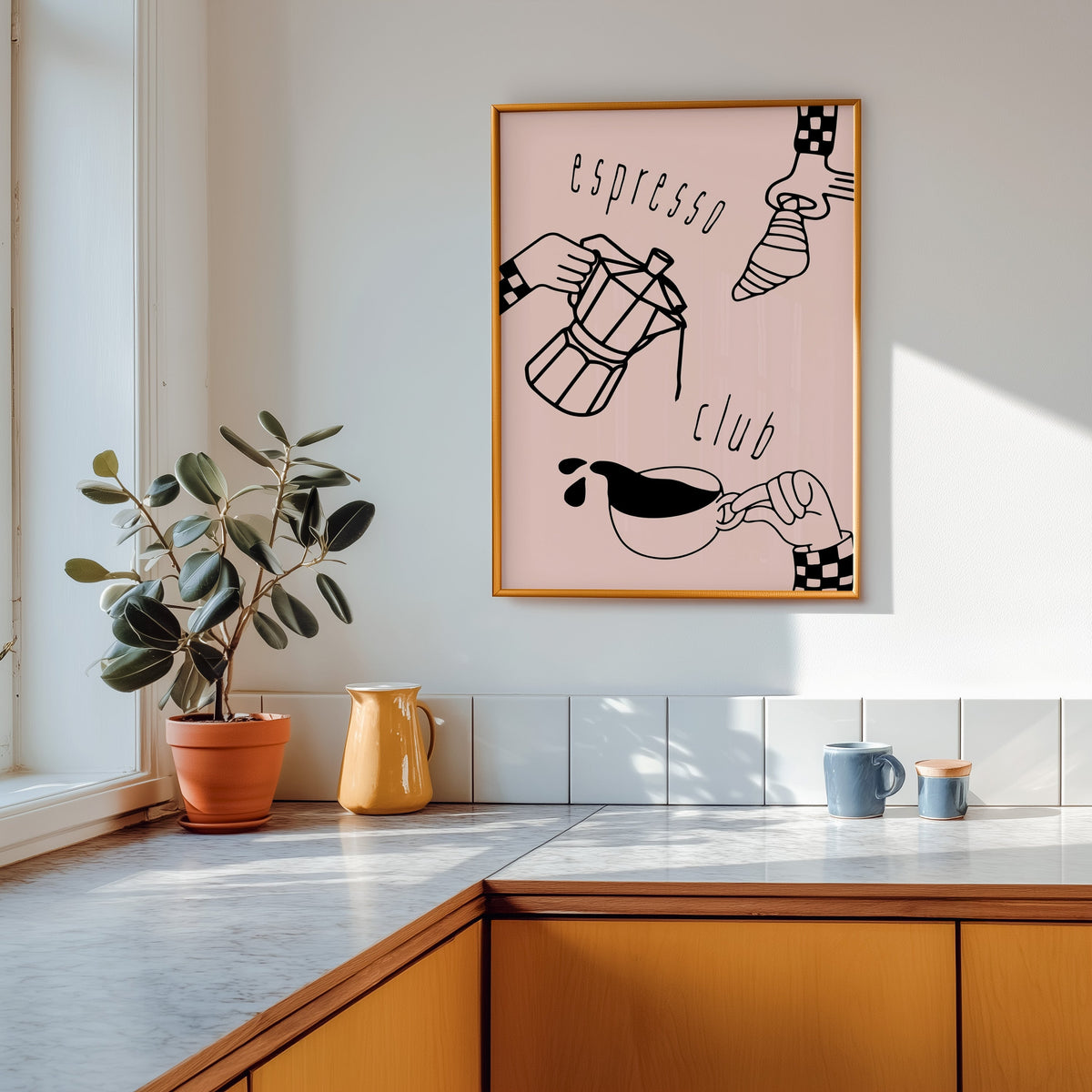 Espresso Club print shown in a gold frame above a marble counter with a yellow ceramic jug