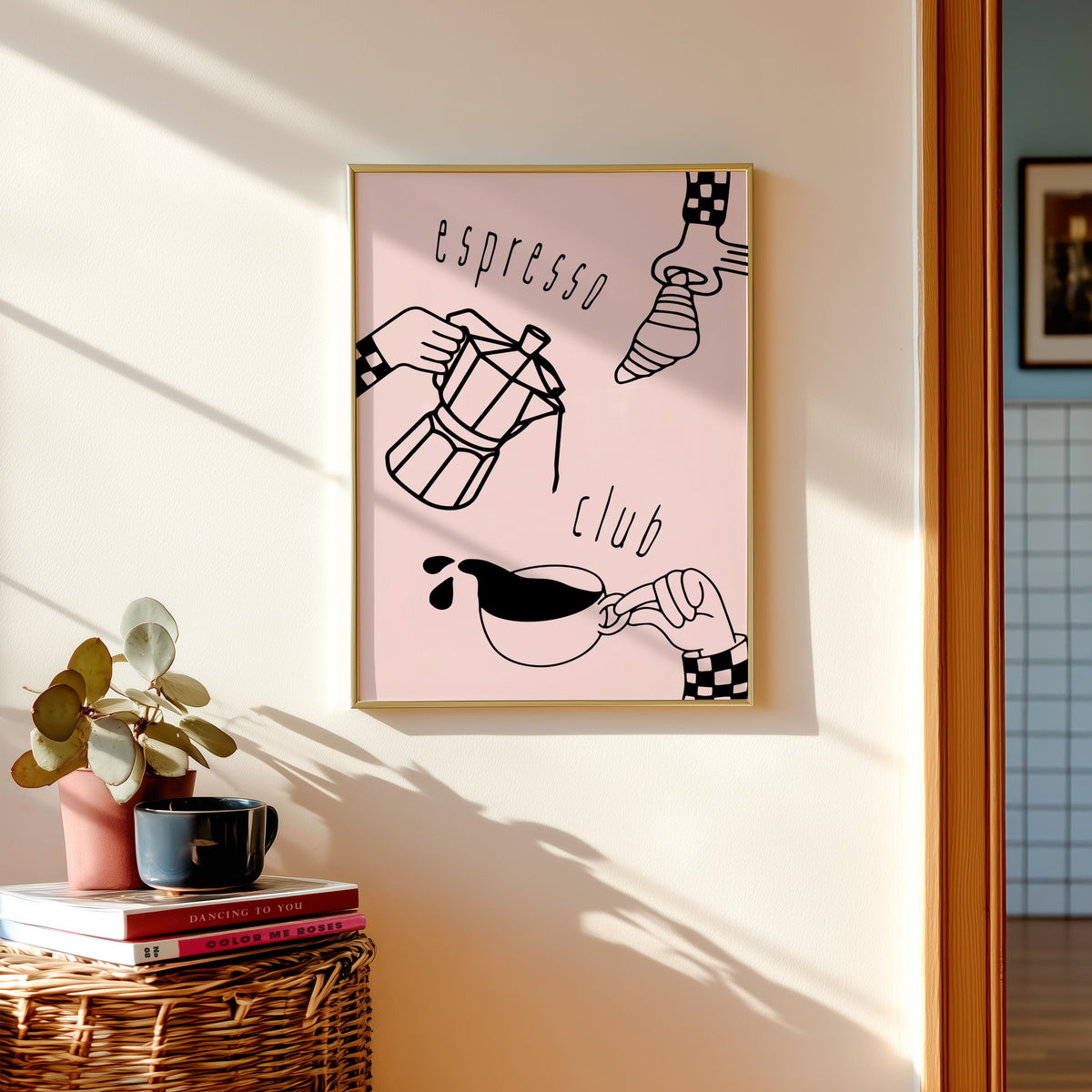 Espresso Club print shown in a gold frame above a basket of books and a pilea plant