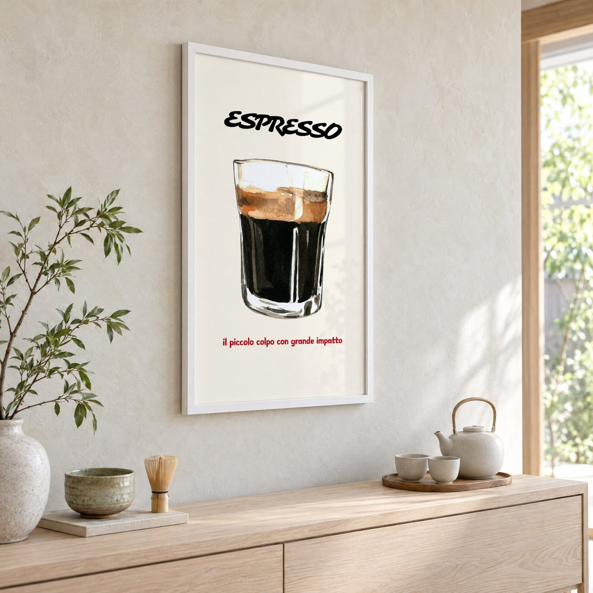 ESPRESSO watercolor glass print in a white frame above a pale wood console with a matcha tea set