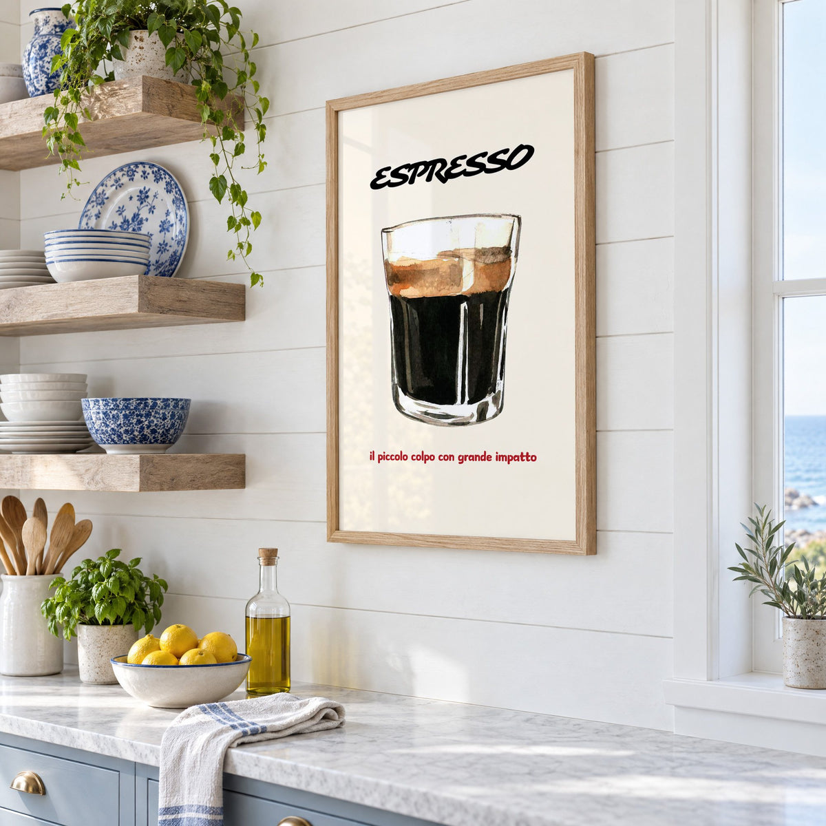 ESPRESSO watercolor glass print in an oak frame in a white coastal kitchen beside blue and white plates