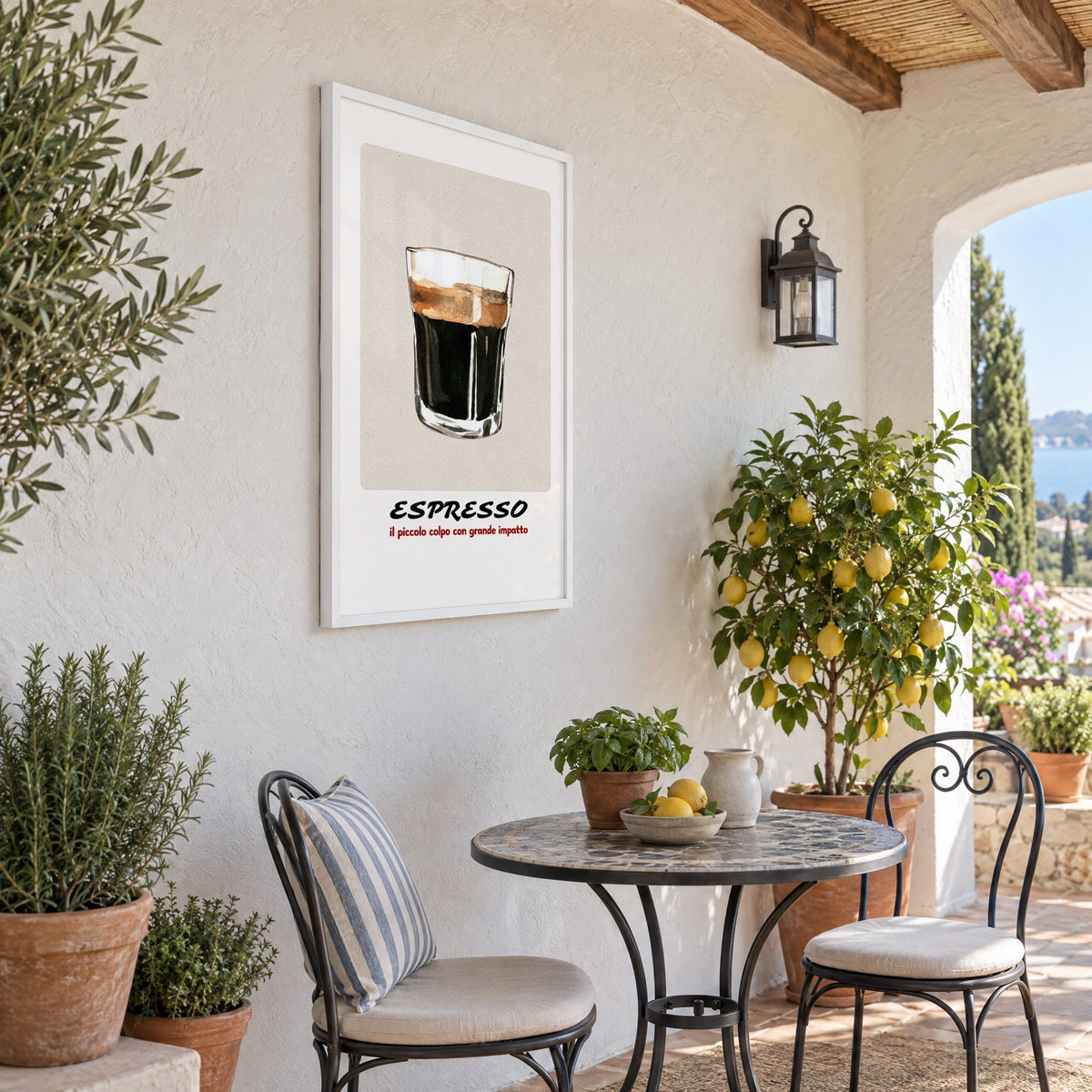 ESPRESSO watercolor glass print in a white frame on a sunny patio wall beside a potted lemon tree