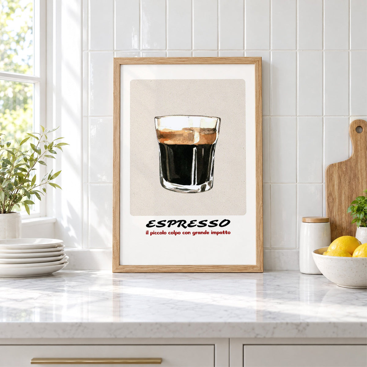 ESPRESSO watercolor glass print in an oak frame leaning on a marble counter by white tiles and lemons