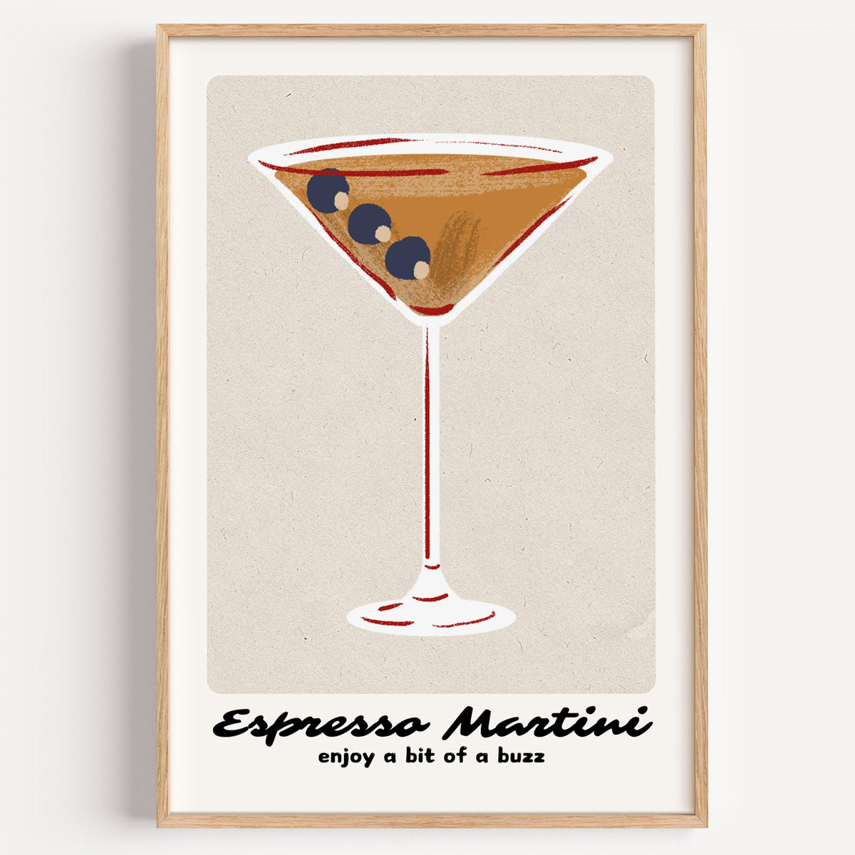 Espresso Martini cocktail glass print in a light oak frame on a plain white wall