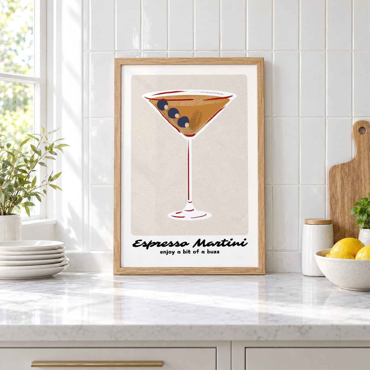 Espresso Martini cocktail glass print in an oak frame leaning on a marble counter by white tiles and lemons