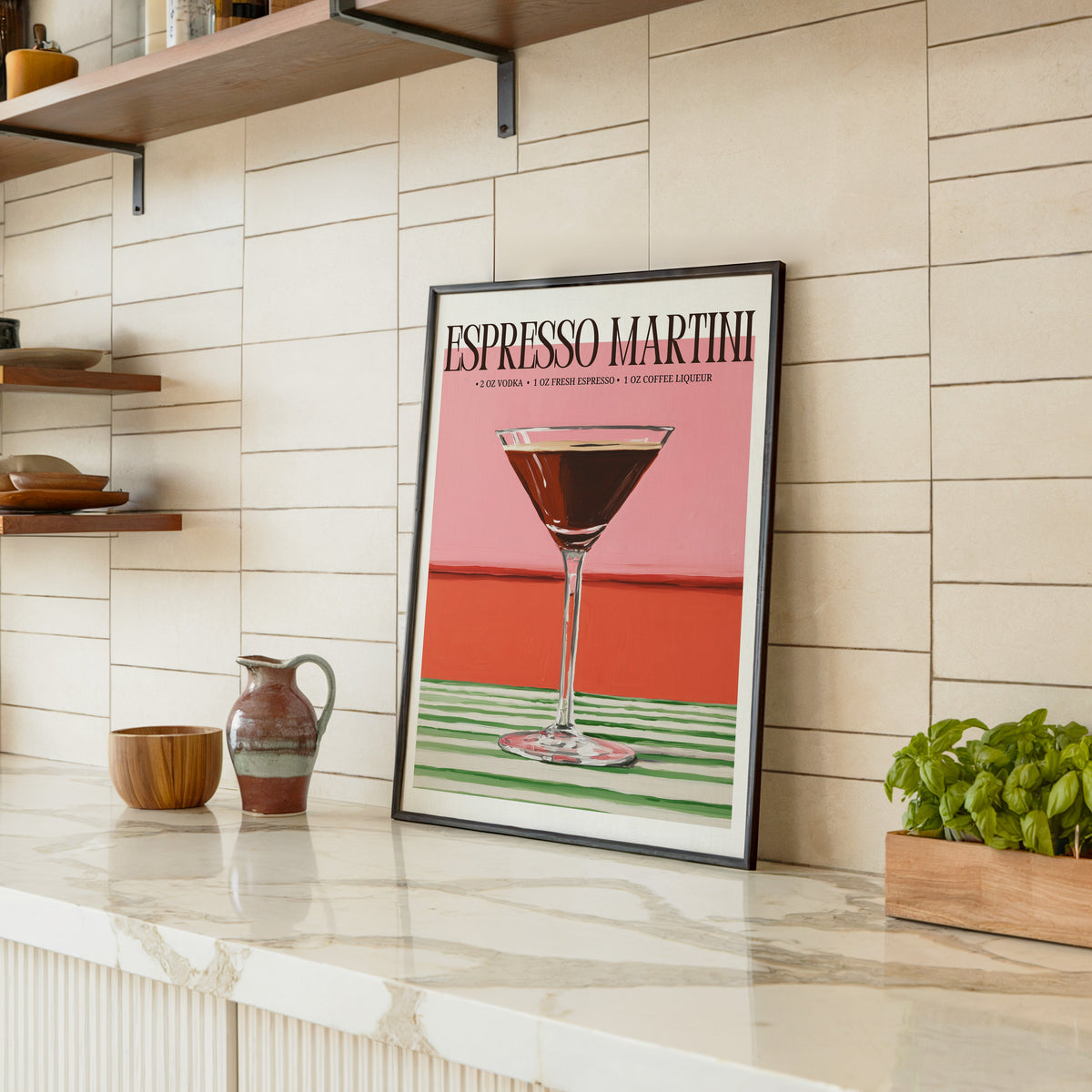 Espresso martini recipe print in a black frame leaning on a marble counter in a tiled kitchen