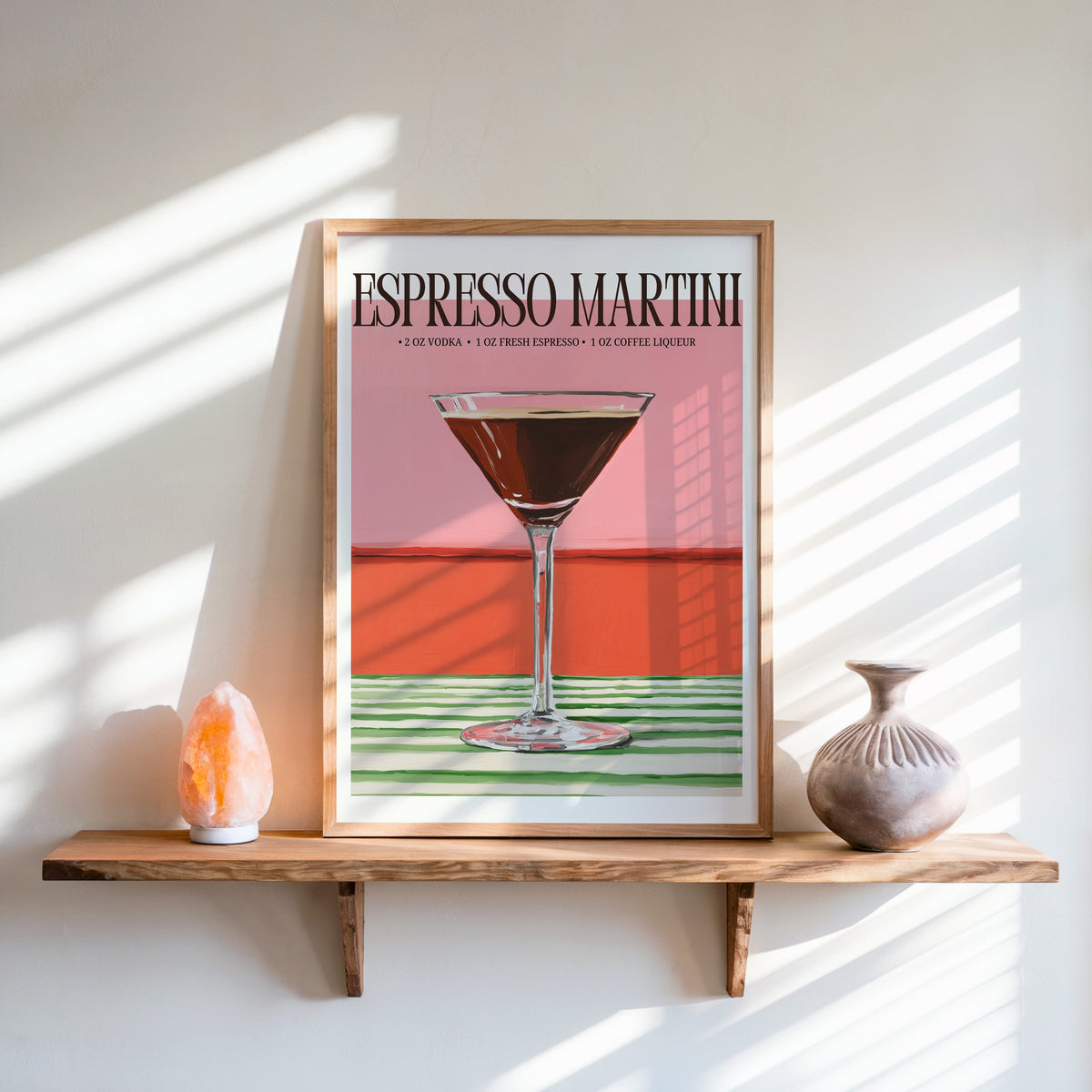 Espresso martini recipe print in an oak frame on a live-edge shelf beside a salt lamp
