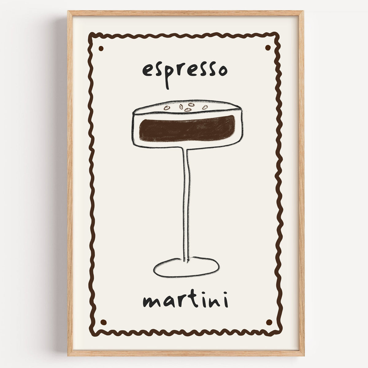 Espresso martini pencil line print in a light oak frame on a plain white wall