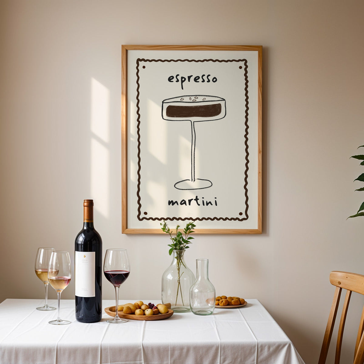 Espresso martini pencil line print in an oak frame above a table laid with red wine and glasses