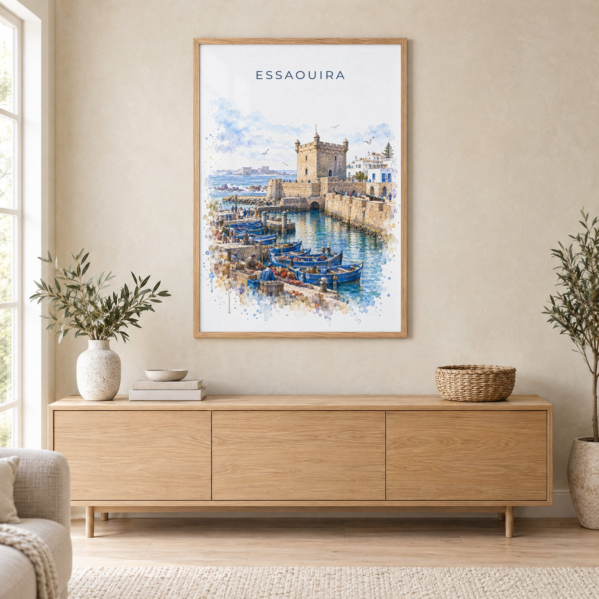Essaouira watercolor print in an oak frame above a light wood sideboard in a Scandinavian living room