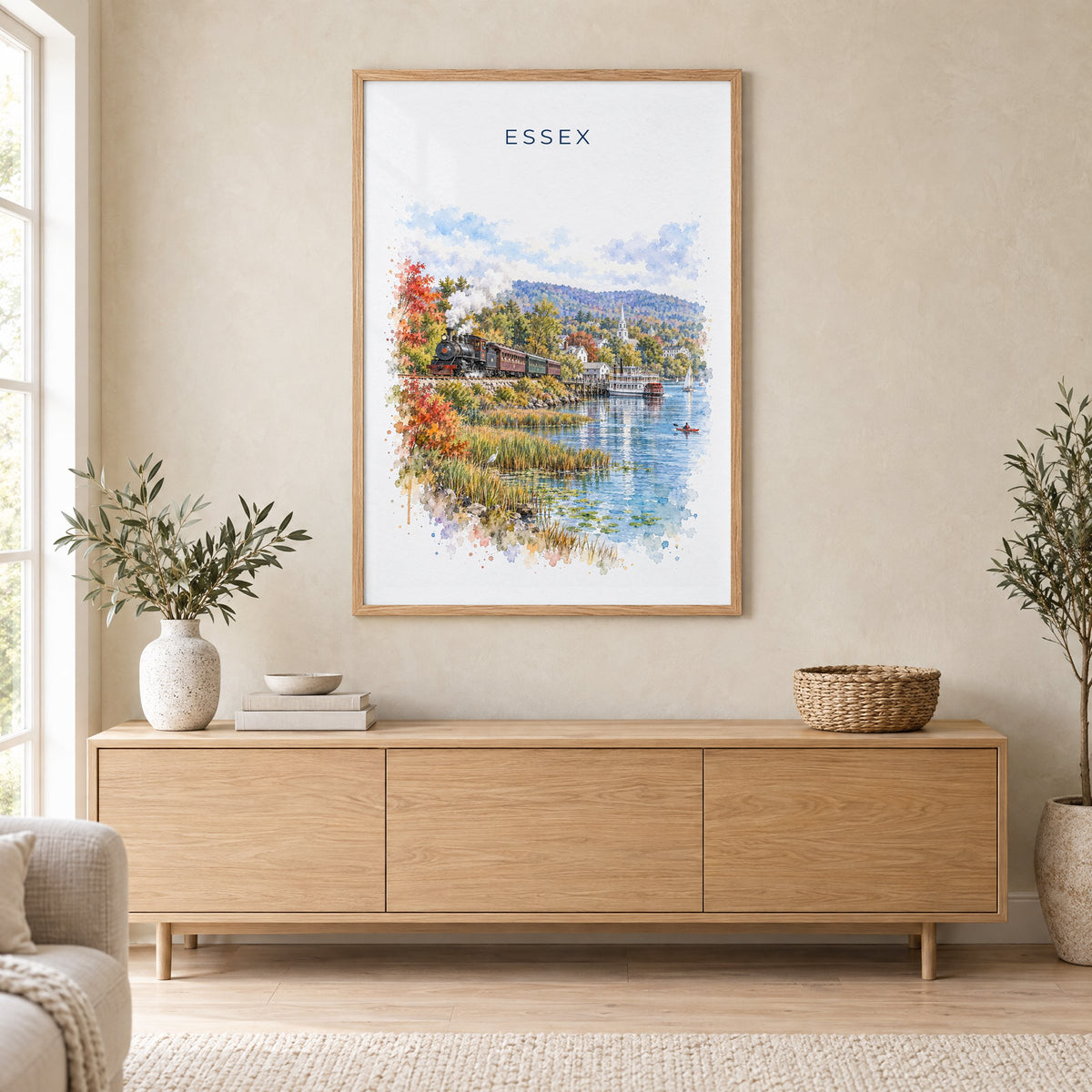 Essex, Connecticut watercolor print in an oak frame above a light wood sideboard in a Scandinavian living room