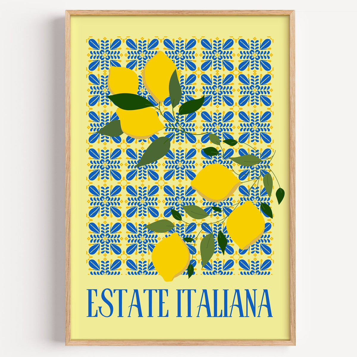Estate Italiana lemon tile print in a light oak frame on a plain white wall