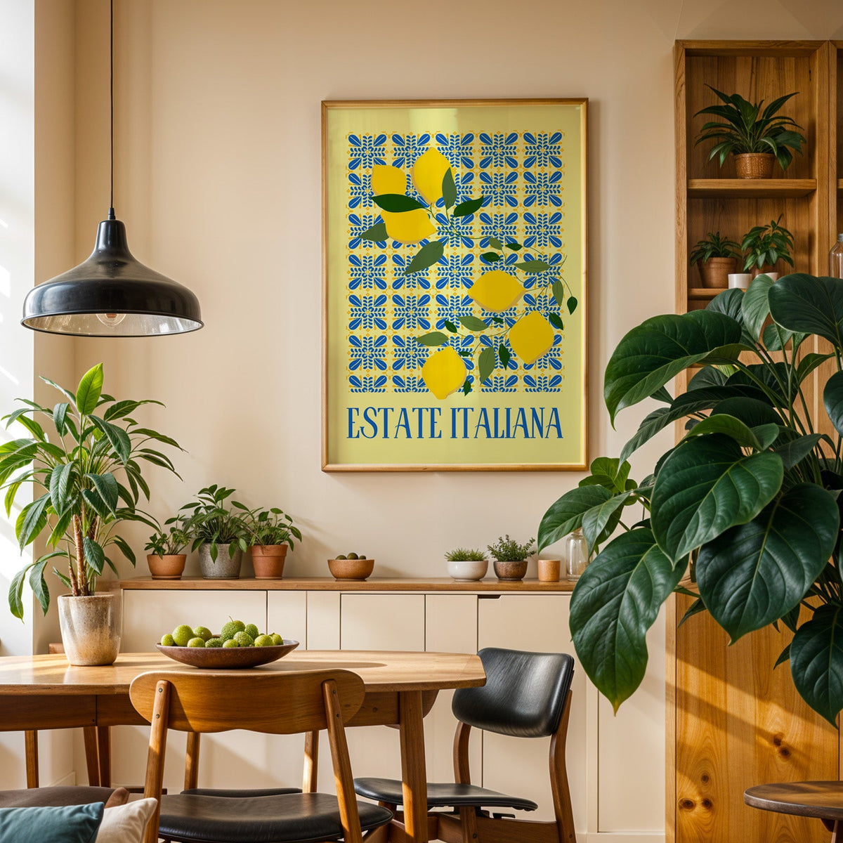 Estate Italiana lemon print in an oak frame in a dining room above a plant-lined sideboard