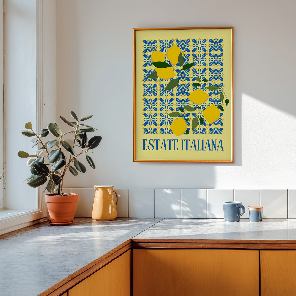 Estate Italiana lemon print shown in a gold frame above a marble counter in a tan kitchen