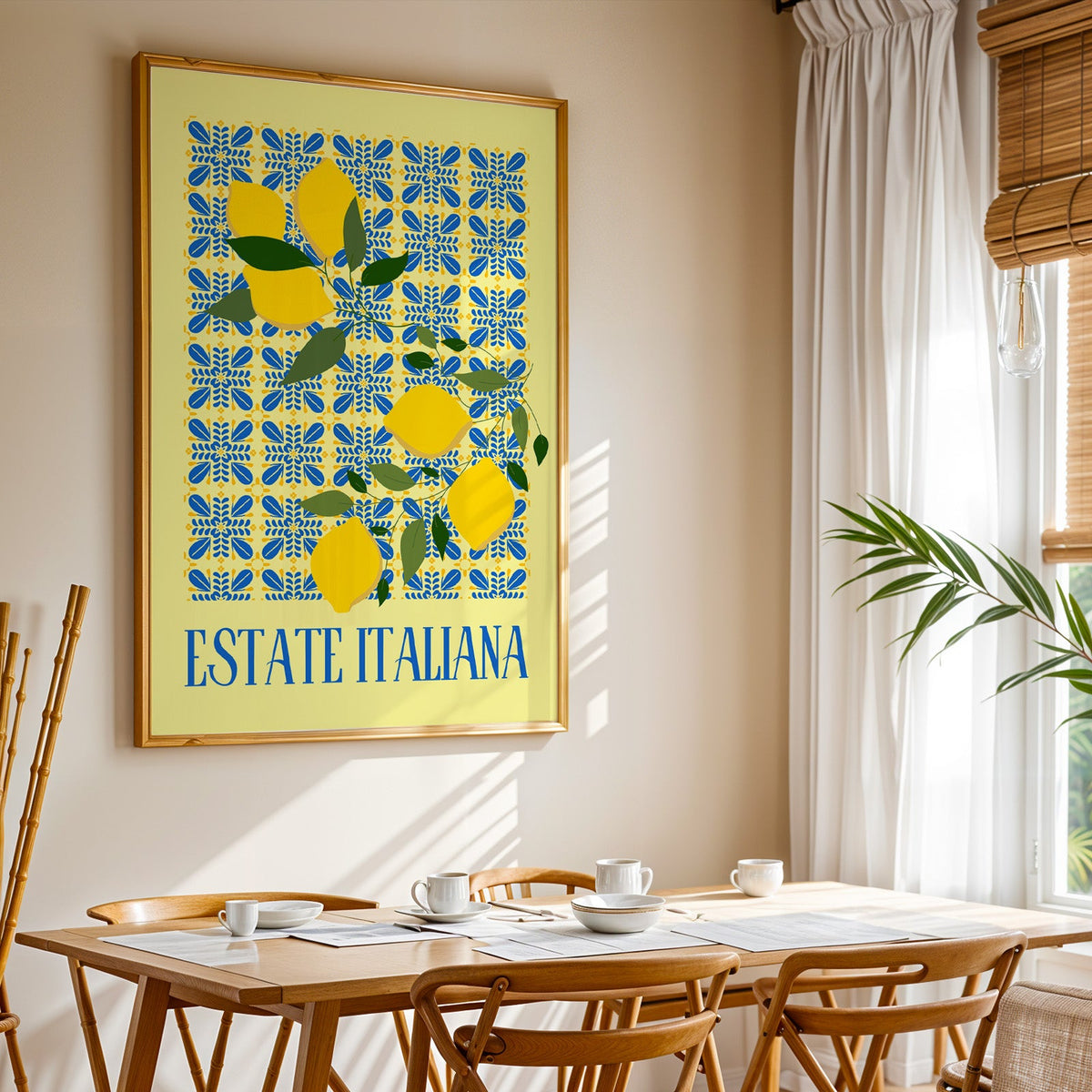 Estate Italiana lemon print shown in a gold frame above a breakfast table by a curtained window