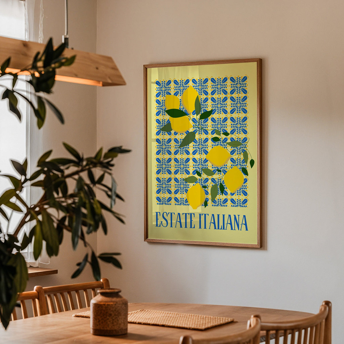Estate Italiana lemon print in a walnut frame above a dining table with olive branches